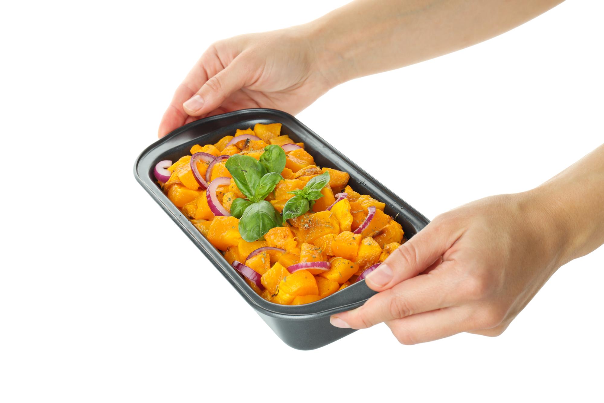 hands packing meal kit at bench