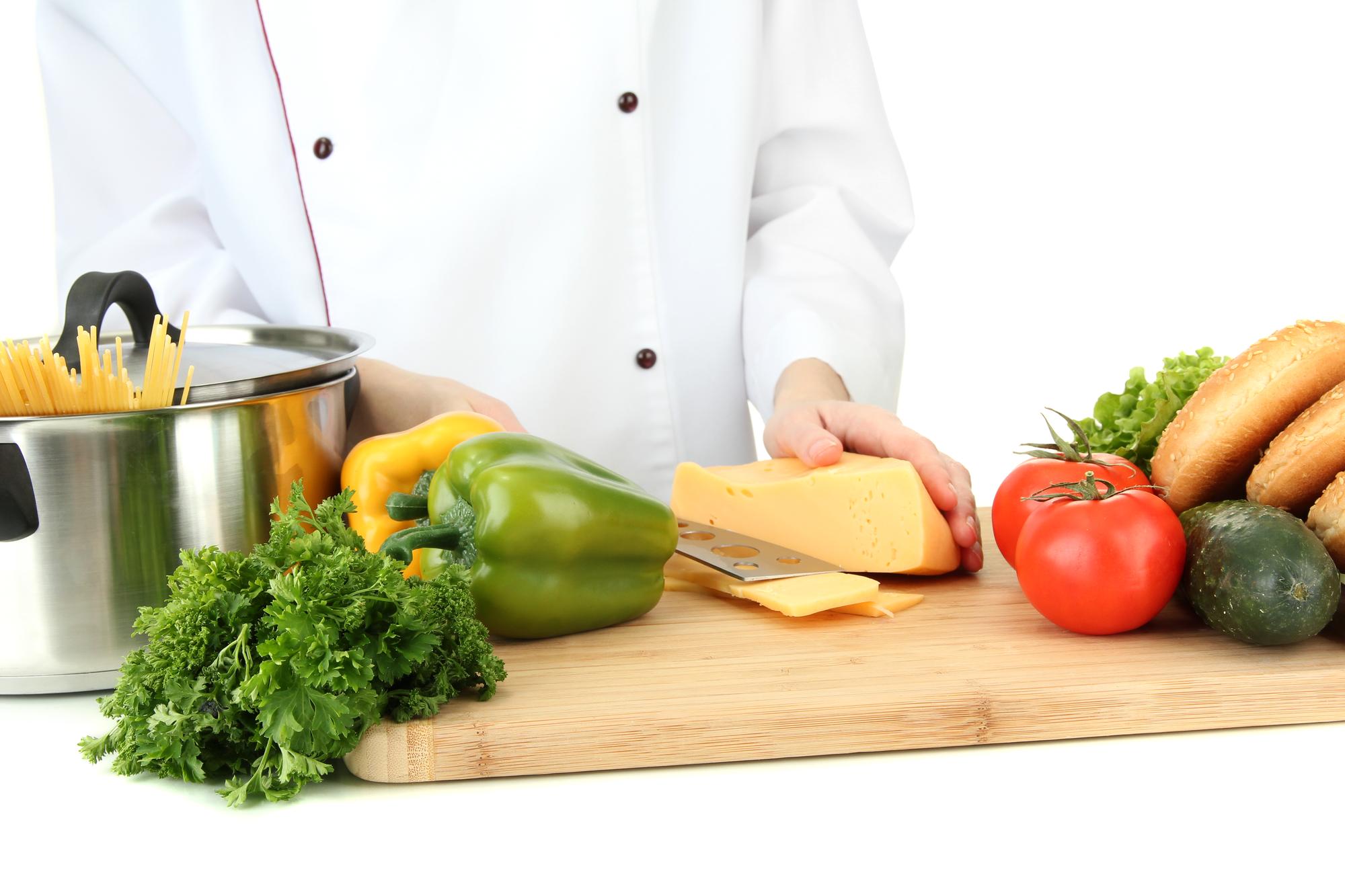 chef arranging fresh ready-to-cook ingredients on counter